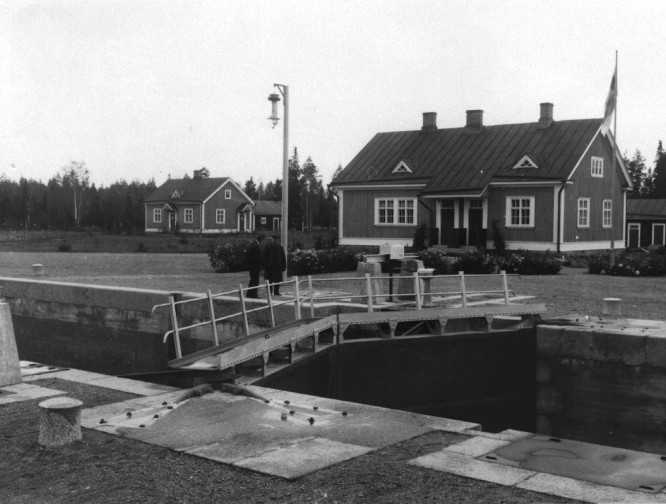 House by the channel with bridge in the foreground